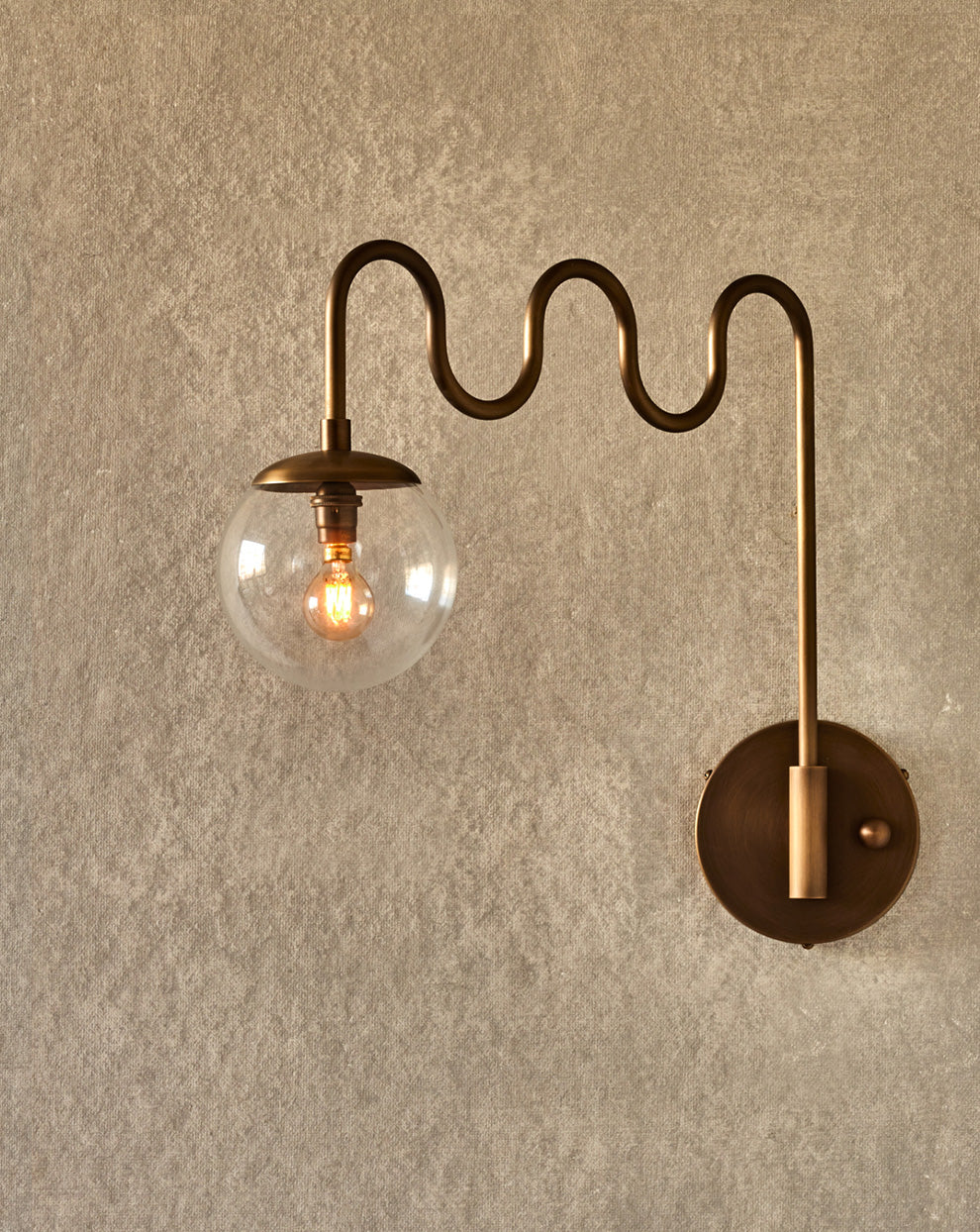 Cecil Wall Lamp – Undulating Bent Brass Arm & Swivel Glass Globe Sconce