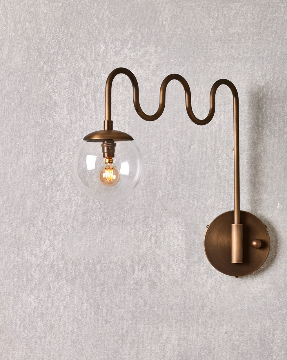Cecil Wall Lamp – Undulating Bent Brass Arm & Swivel Glass Globe Sconce